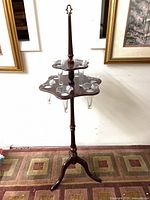 Full view of wooden two-tier plant stand with glass inserts