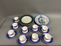 Full set showing plate, four bowls, seven demitasse cup and saucer sets