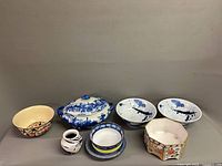 All items grouped: tureen, oval bowl, two splatter bowls, planter, vase, small bowl, two plates