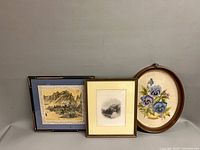 Group shot of three framed artworks