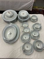 Full set arranged showing plates, cups, saucers, platter, bowl, sugar bowl
