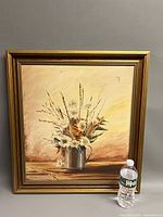Framed painting with water bottle for scale