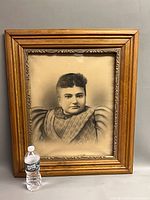 Full view of framed portrait with water bottle for scale