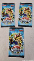 Front view of three sealed boosters with Yugi artwork