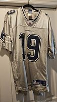 Full front view of Dallas Cowboys #19 jersey on hanger