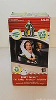 Front of product box showing Buddy the Elf Car Buddy inflatable details