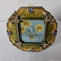 Front view of Jay Strongwater enamel frame with Swarovski crystals and floral insert