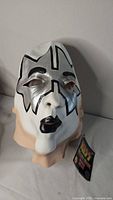 Front view of KISS latex mask with tag