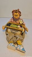 Full view of seated laundry doll with basket