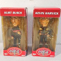 Front view of both boxed bobbleheads showing driver names and packaging