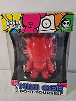 Front view of boxed red Mini Qee figure showing product branding and figure inside