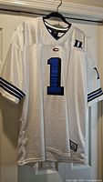Full front view of Duke #1 jersey on hanger