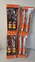 Four boxed pairs of Halloween taper candles, two witch design, two ghost design