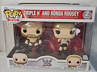 Front view of sealed Funko Pop! WWE Triple H and Ronda Rousey 2-pack box