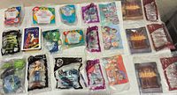 Overview of all sealed Happy Meal toys laid out on table
