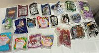 All 20 sealed Happy Meal toys laid out on table