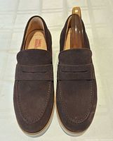 Top view of both loafers with shoe horn inserted