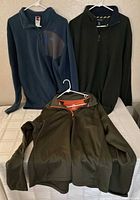 Three pullover jackets displayed together