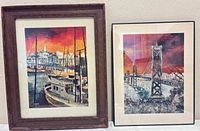Both framed prints standing side by side showing relative sizes and frames