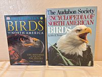 Both hardcover bird reference books side by side showing covers