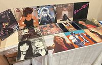 All 13 album covers displayed on table