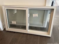 Front view of vinyl slider window showing frame, glass, and latches