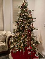 Full view of decorated 7.5ft artificial tree showing integrated lights