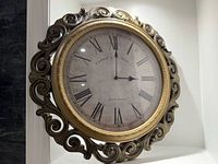 Front view of ornate wall clock