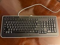 Top view showing full key layout, multimedia keys and attached USB cable