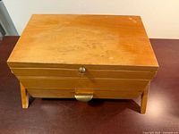 Top view of closed wooden sewing box