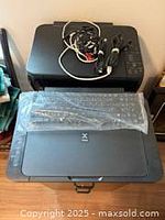 Two Canon Pixma printers stacked with cables on top