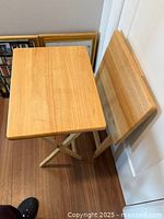 Two wood TV trays, one open one folded, showing size and material