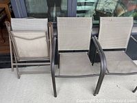 Front view of three beige sling chairs, two armchairs and one folding chair