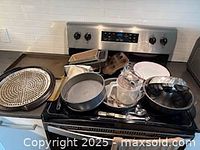 Overall lot with various bakeware on stove