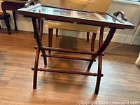Side view of wooden folding butler tray table fully assembled