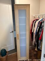 Front view of closed cabinet showing frosted plastic door panel