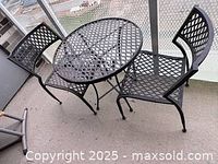 Table and two chairs full view on balcony