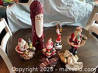 group shot of all Santa figurines, music box and sled
