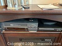 RCA VHS player and Proscan DVD player side by side in entertainment unit