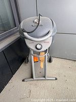Front view of Char-Broil electric grill showing lid, thermometer, control knob, power cord