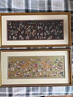 Both framed embroidered silk panels side by side