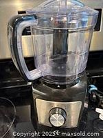 Black food processor with clear bowl and lid