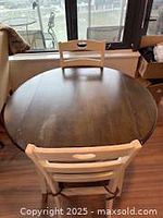 Round table with both leaves up and one chair