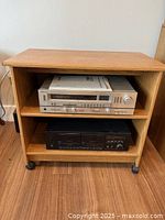 Front view showing two shelves, contents excluded, on casters