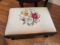 Beige rectangular footstool with floral needlepoint top