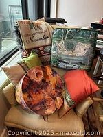 All items displayed on chair: throw, Sandra Hudson cushion, two silk pillows, floral hat box