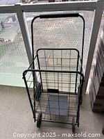 Front angled view of black folding wire shopping cart