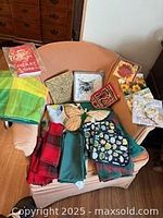 All table linens, potholders and napkin packs arranged on chair