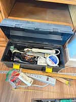 open toolbox showing drill, bits, power bar, rulers