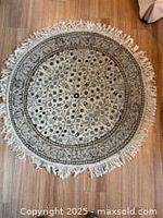 Front view of round Turkish rug showing full pattern and fringe